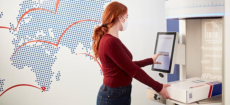 Lady using Quick Drop Kiosk